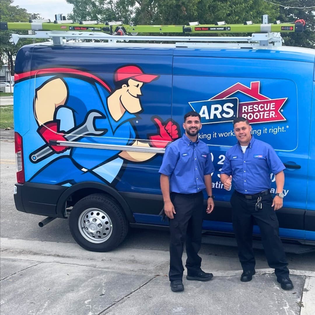 ARS / Rescue Rooter technicians beside their service van